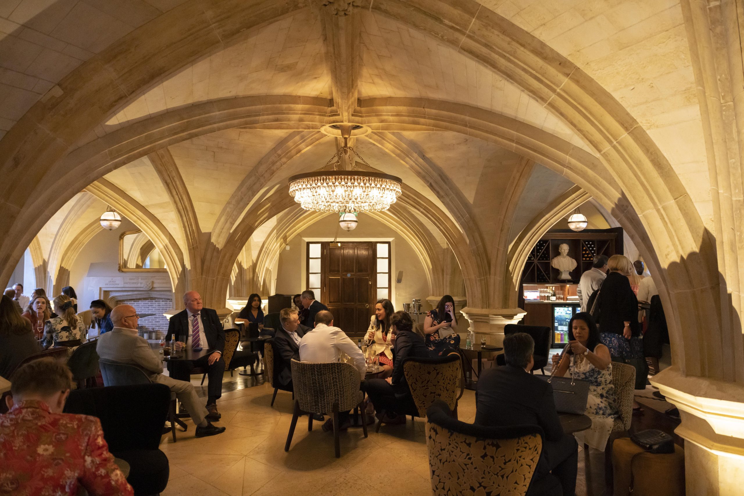 Restaurant with domed ceilings and chandelier filled with guests sat at tables for drinks