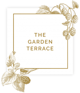 Sign saying the garden terrace in square with floral decorations
